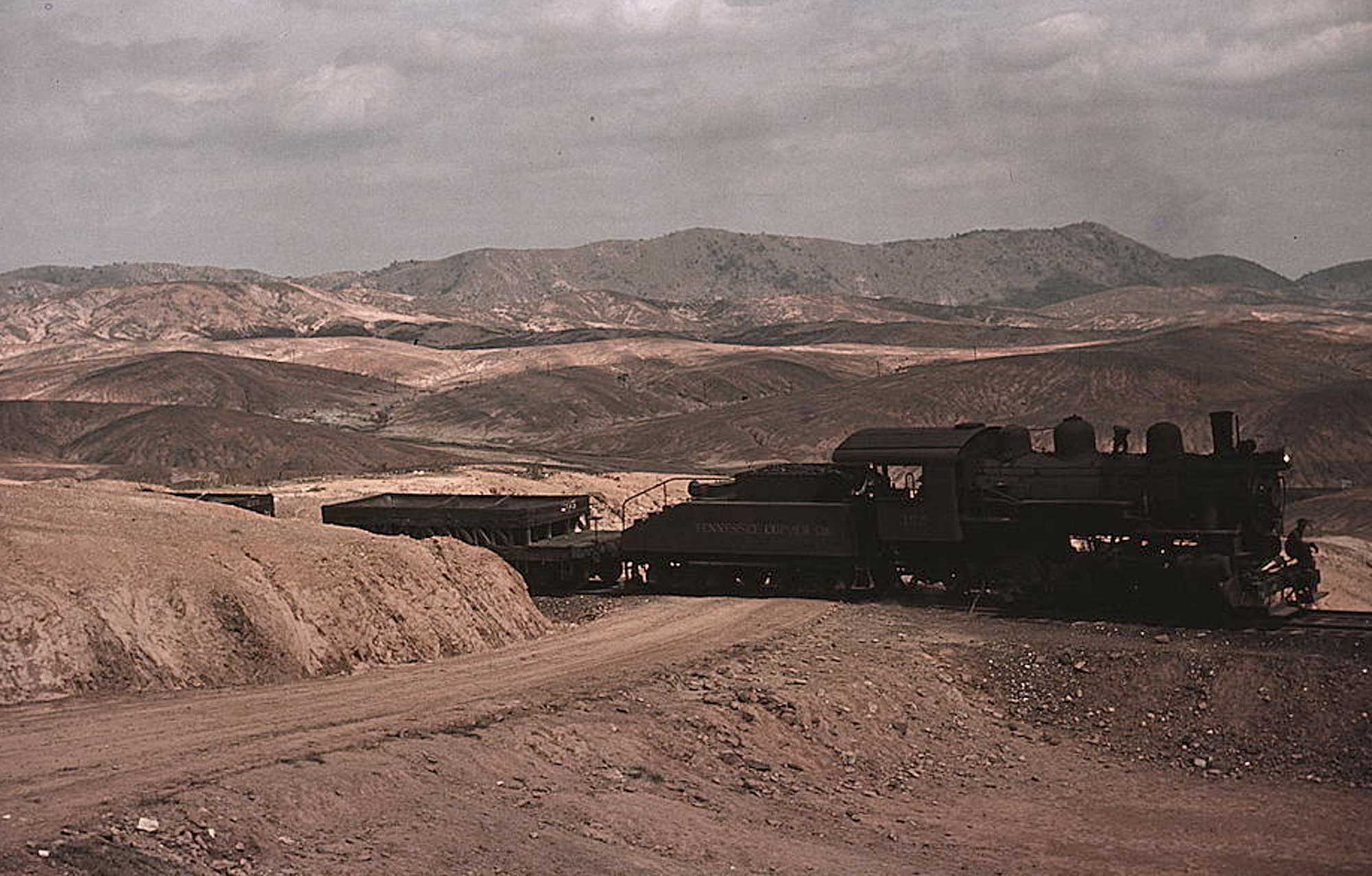 Photograph of a train hauling copper ore out of a mine in Ducktown, Tennessee.