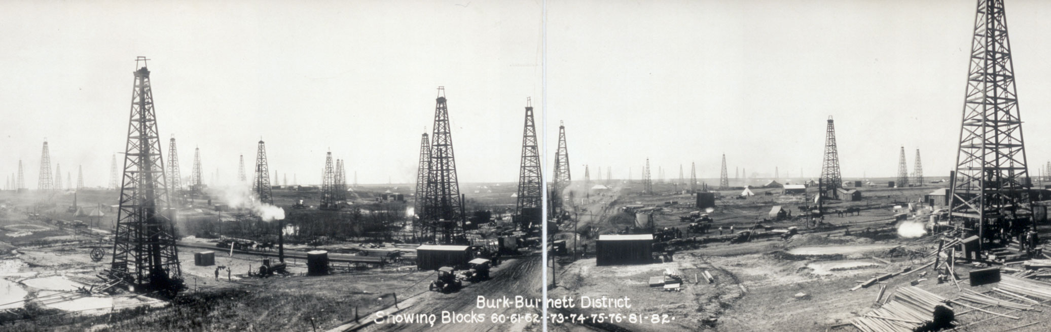 Black-and-white panoramic photo of oil derricks in the Burk-Burnett district, Fort Worth Basin, ca. 1919.