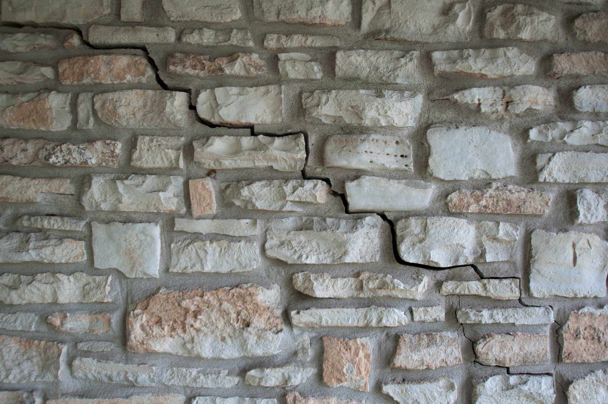 Photograph of a cracked brick wall in Austin, Texas.