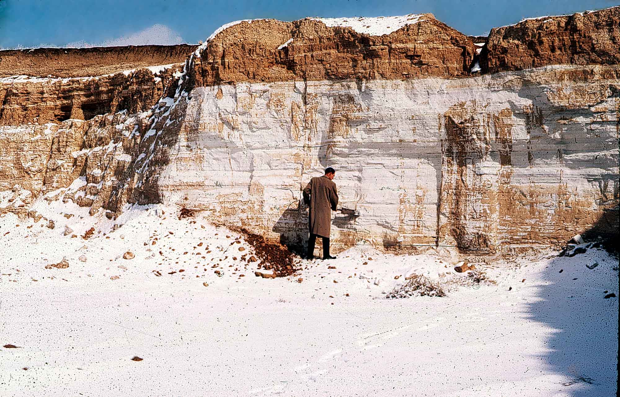 Photograph of a man shoveling ash from a Pearlette Ash deposit in Kansas.