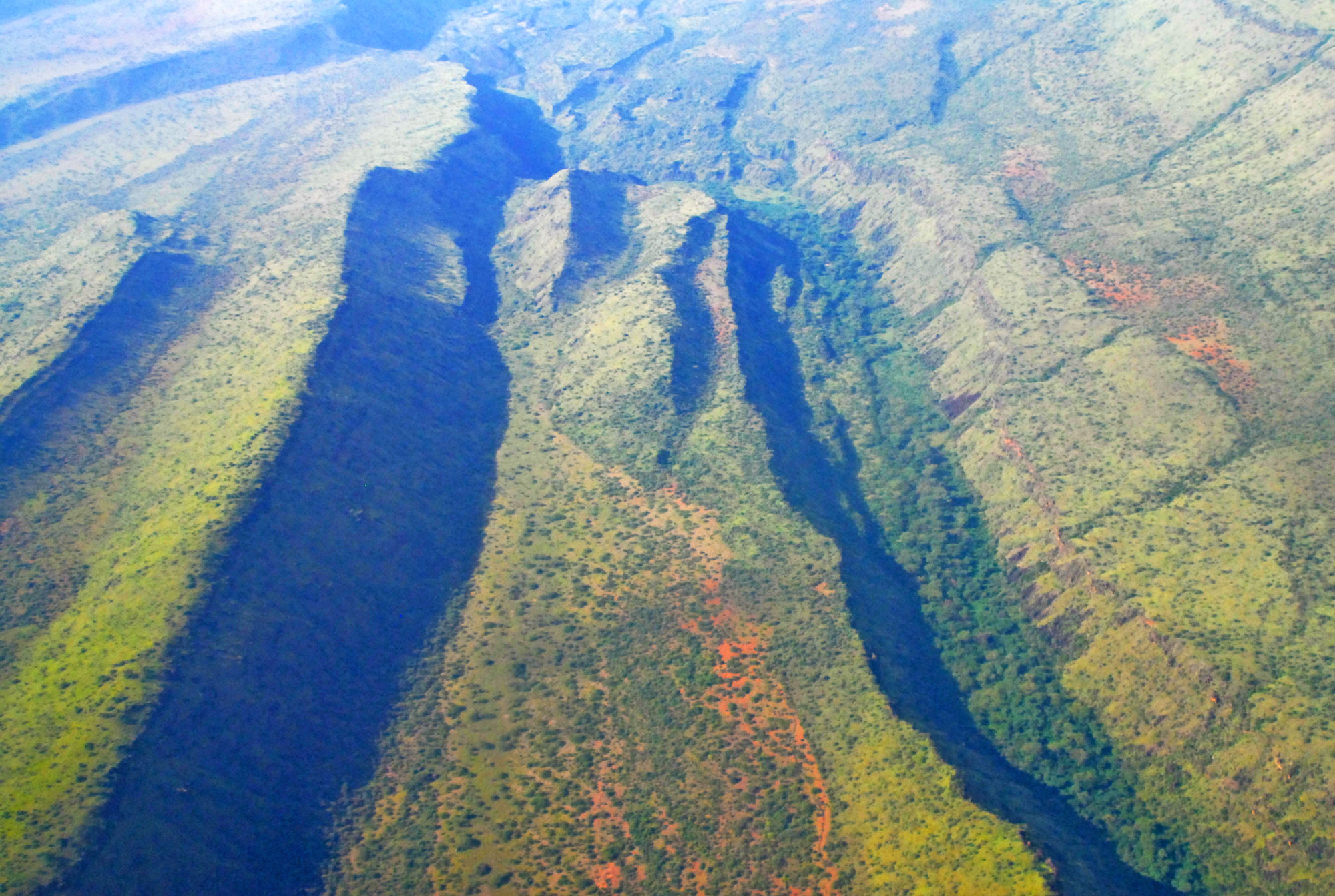 Aerial photo of a rift valley in Kenya. The valley is elongated with steep, parallel sides.