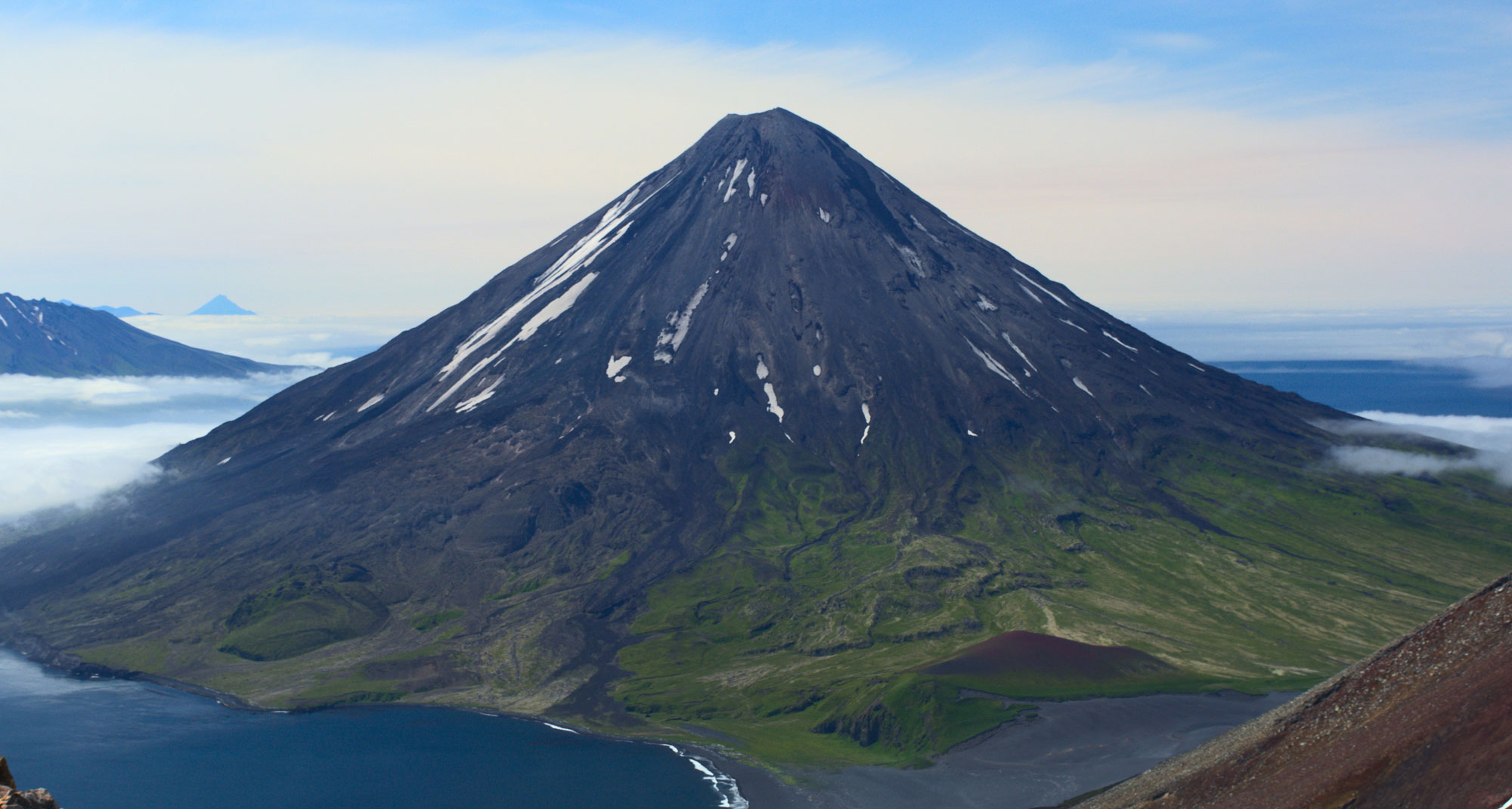 Photo of Mt. Cleveland in the Aleutian Islands, a typical cone-shaped volcano.