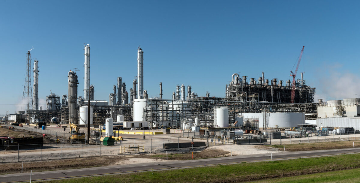 Photograph of an oil refinery in Groves, Texas, 2014. The photo is a landscape with structures for refining oil.