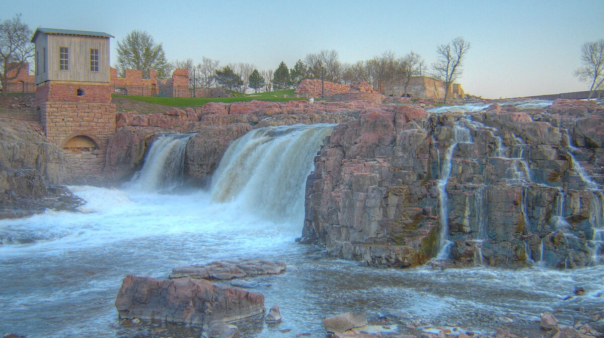 Photograph of the falls on the Big Sioux River in Sioux Falls, South Dakota, at sunset. The falls flow over the Sioux quartzite, which is pinkish in color.