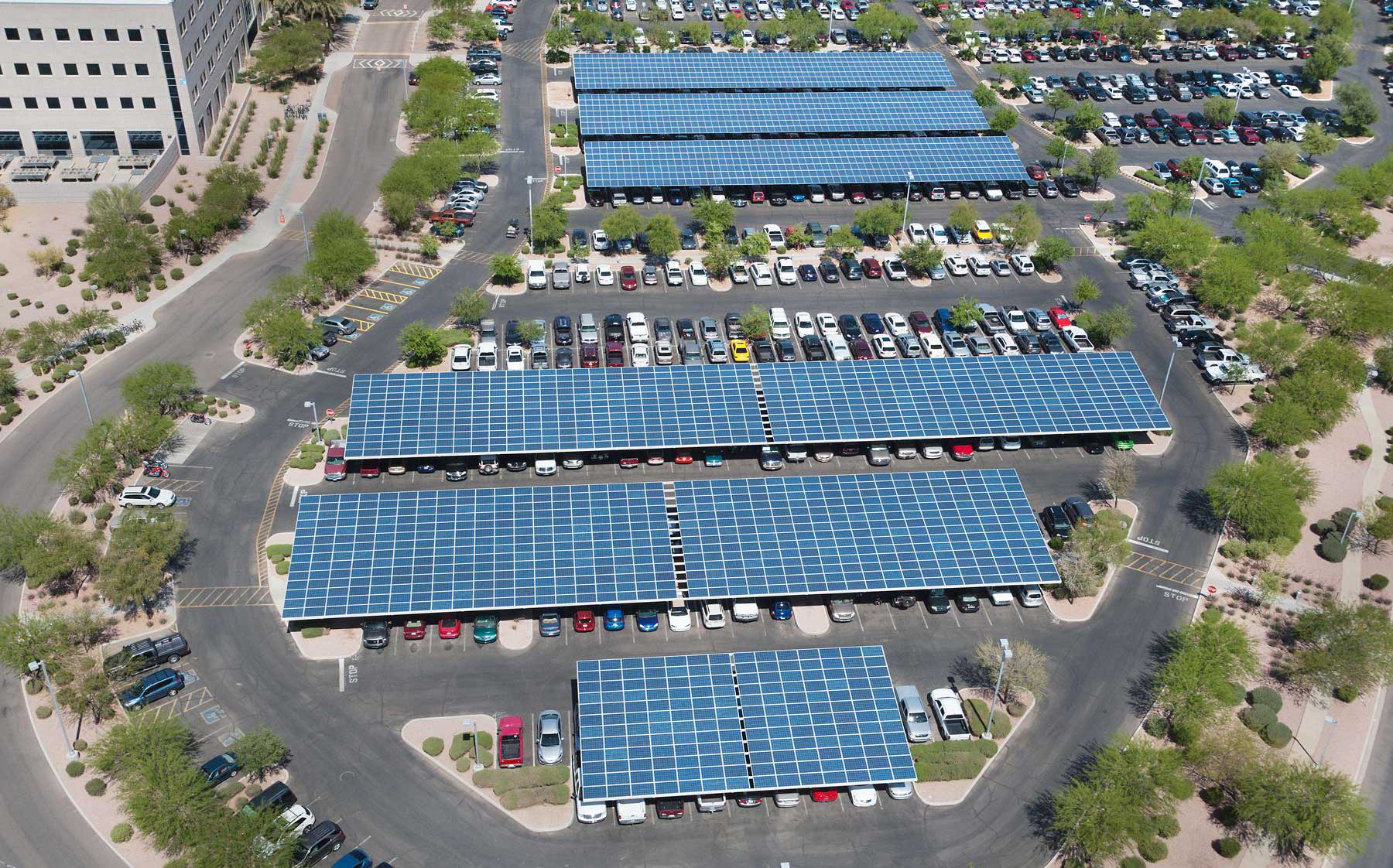 Photograph of a parking lot in Arizona that is partially covered with platforms. The platforms have solar panels on the roofs.