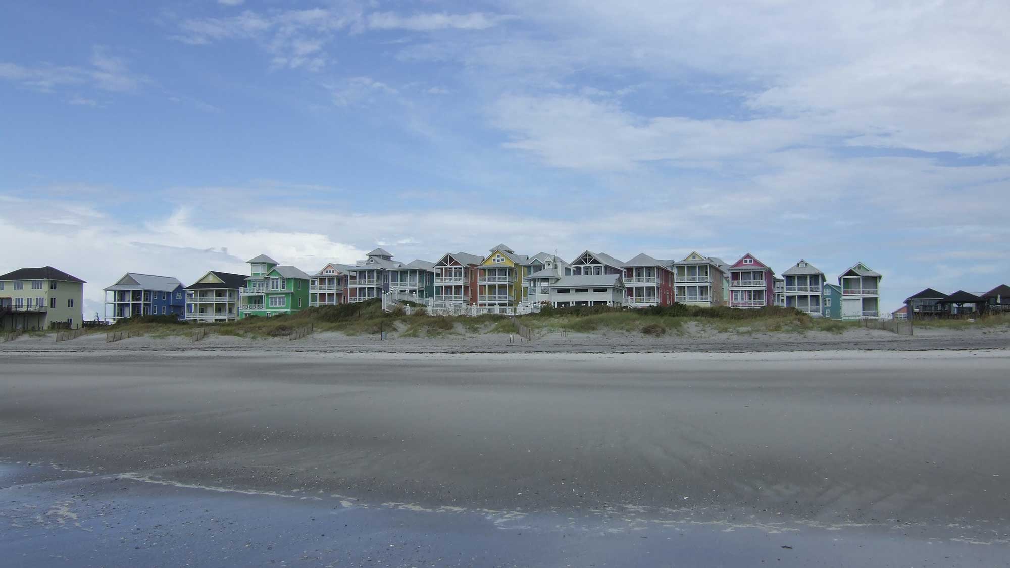 Photograph of houses on the beach of the Atlantic shore of North Carolina.