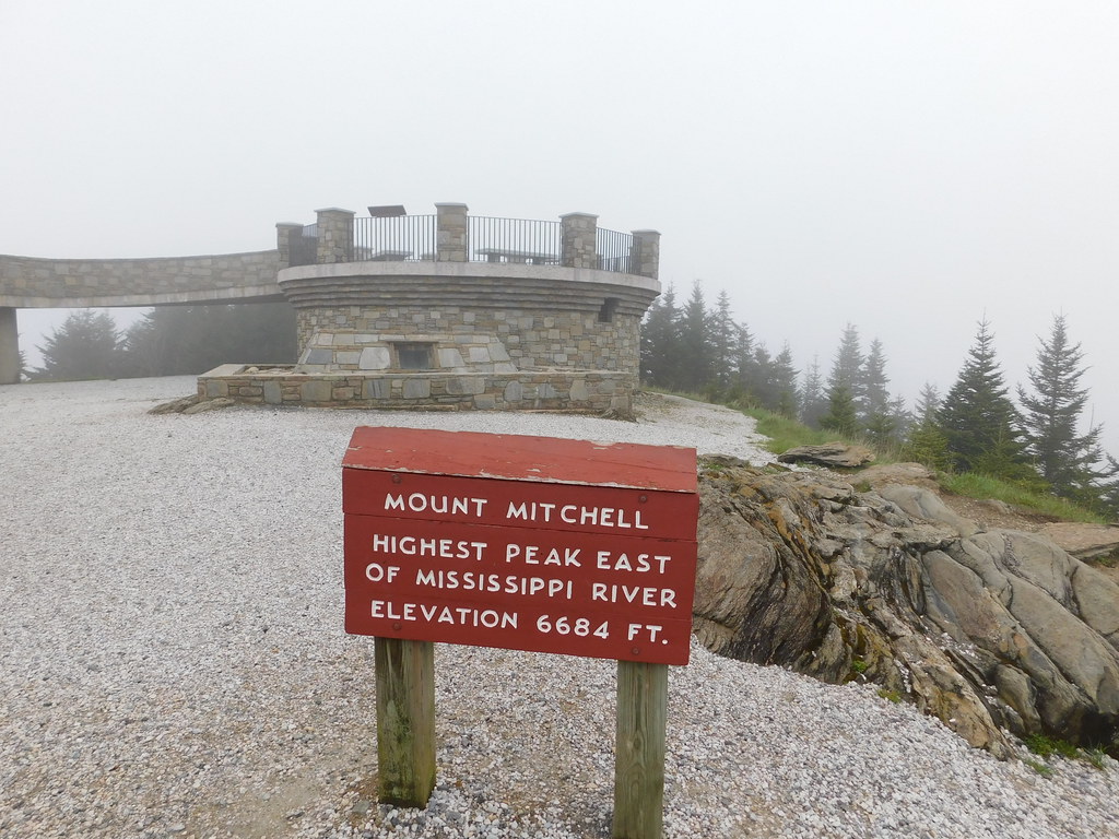 Photograph showing the observation deck at Mount Mitchell, including a sign that records the elevation of 6684 feet.