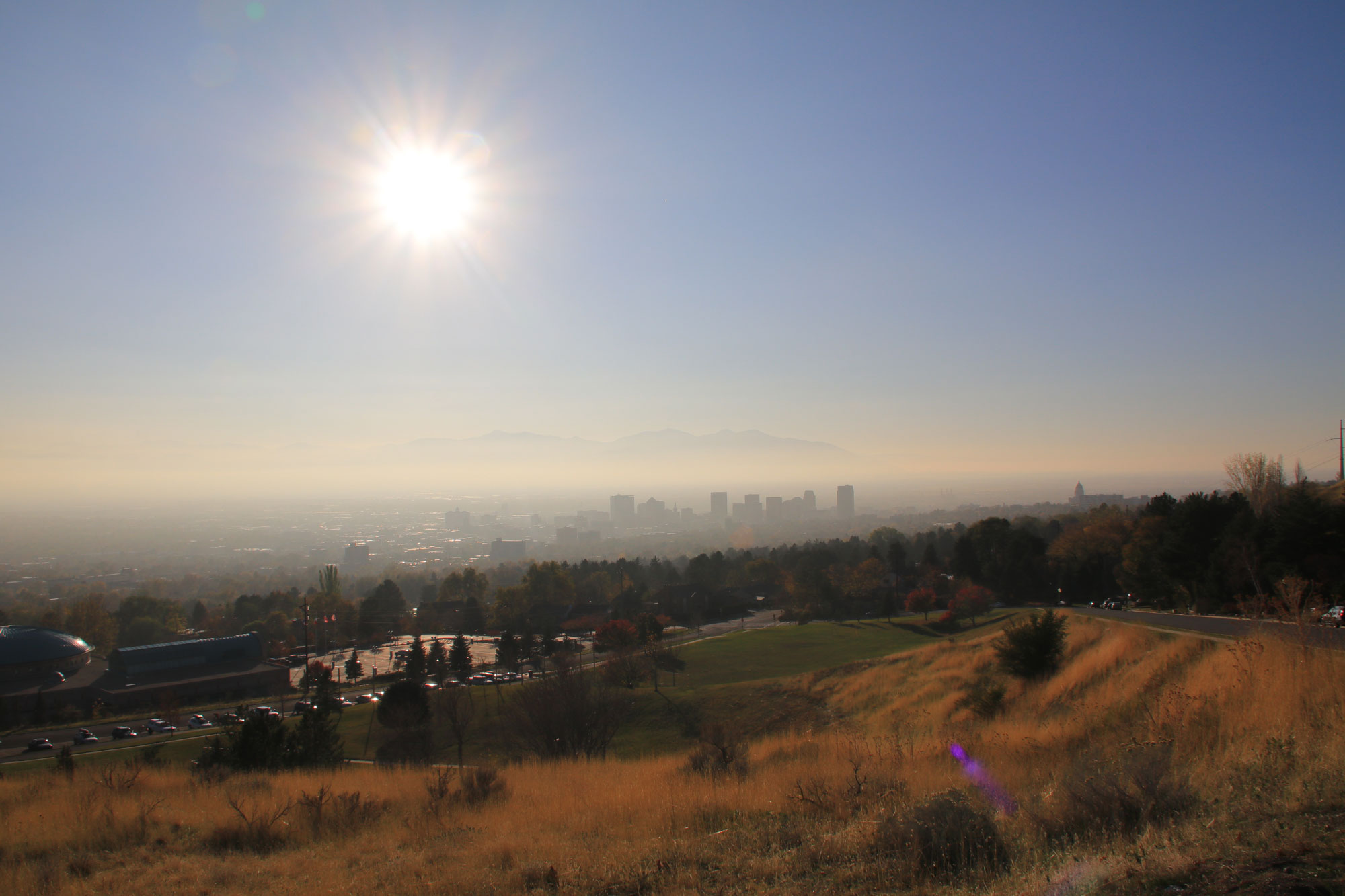 Photograph showing Salt Lake City, barely visible in the distance due to a haze caused by smog.