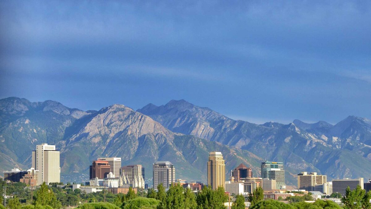 Photograph of the Wasatch Mountains behind buildings of Salt Lake City, Utah.