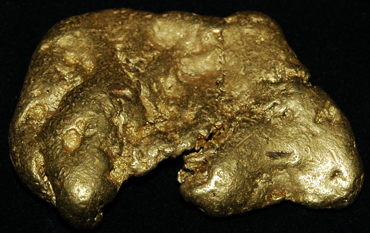 Photograph of a gold nugget. The nugget is irregular in shape.