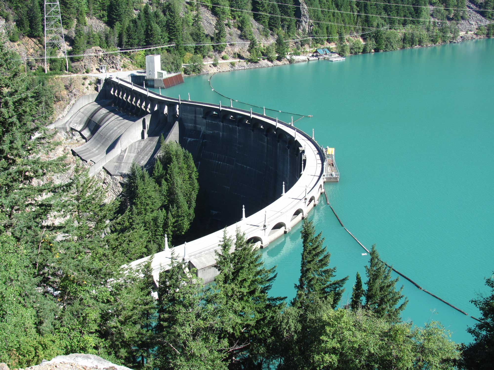 Photograph of Diablo Dam in northwestern Washington state. The photo shows the dam holding back blue-green water.
