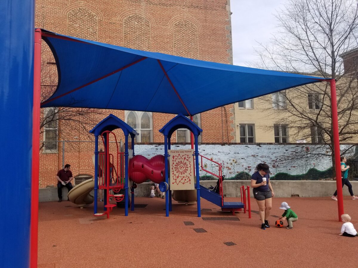 Photo of a playground with awnings that provide shade.