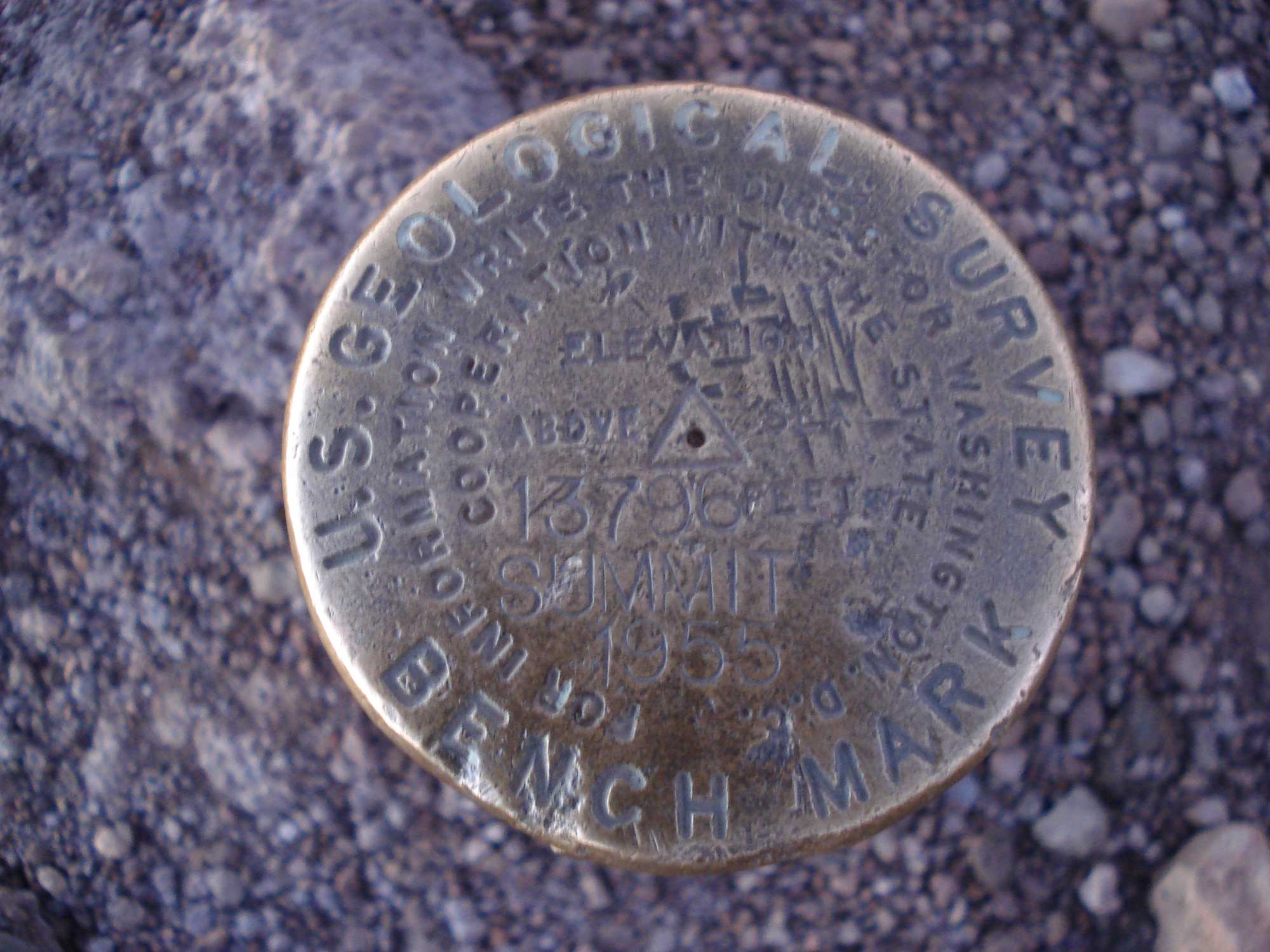 Photograph of the USGS marker that indicates the summit of Mauna Kea in Hawaii.