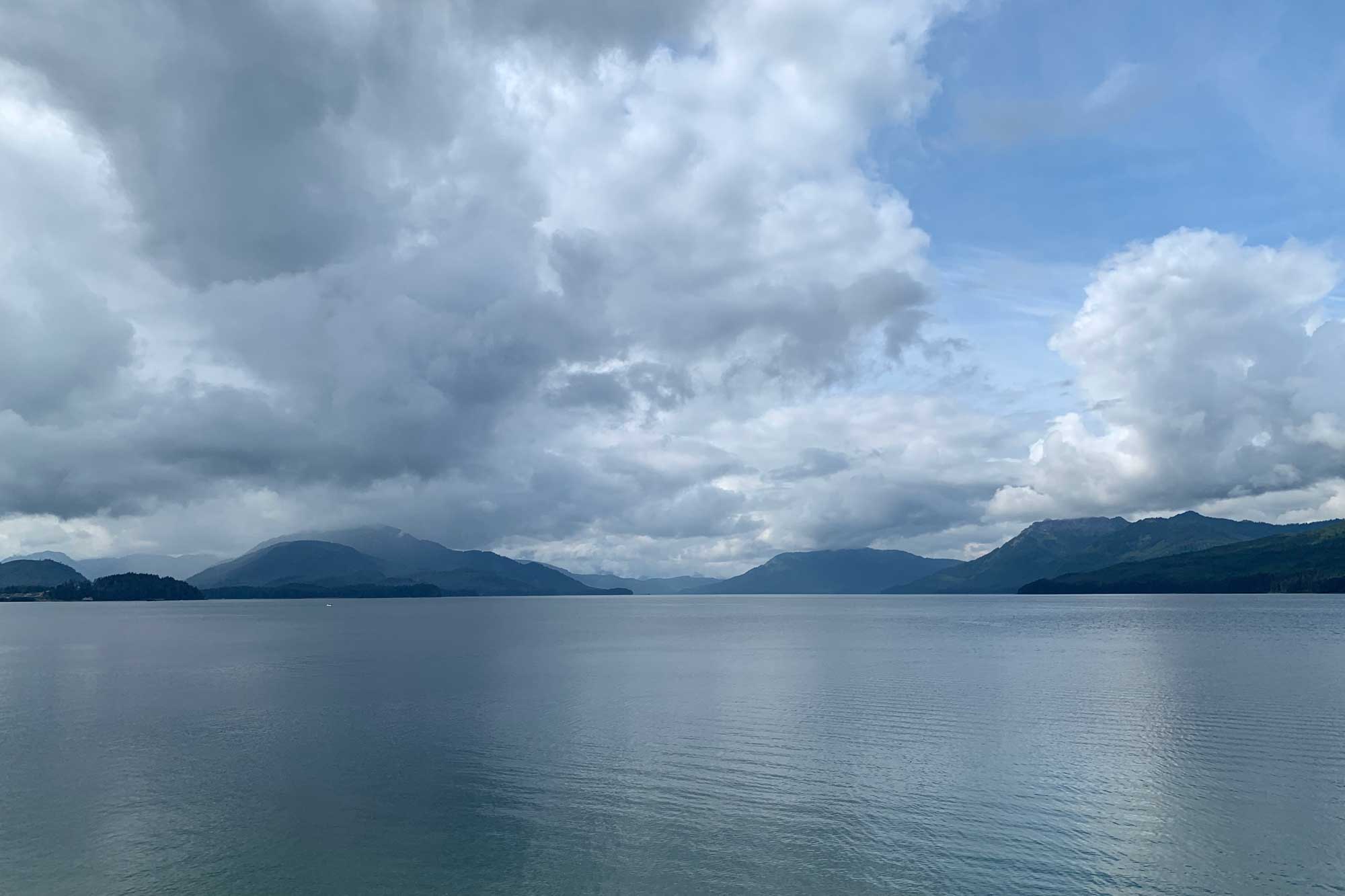 Photograph of a bay with mountains in the distance at Hoonah-Angoon, Alaska.