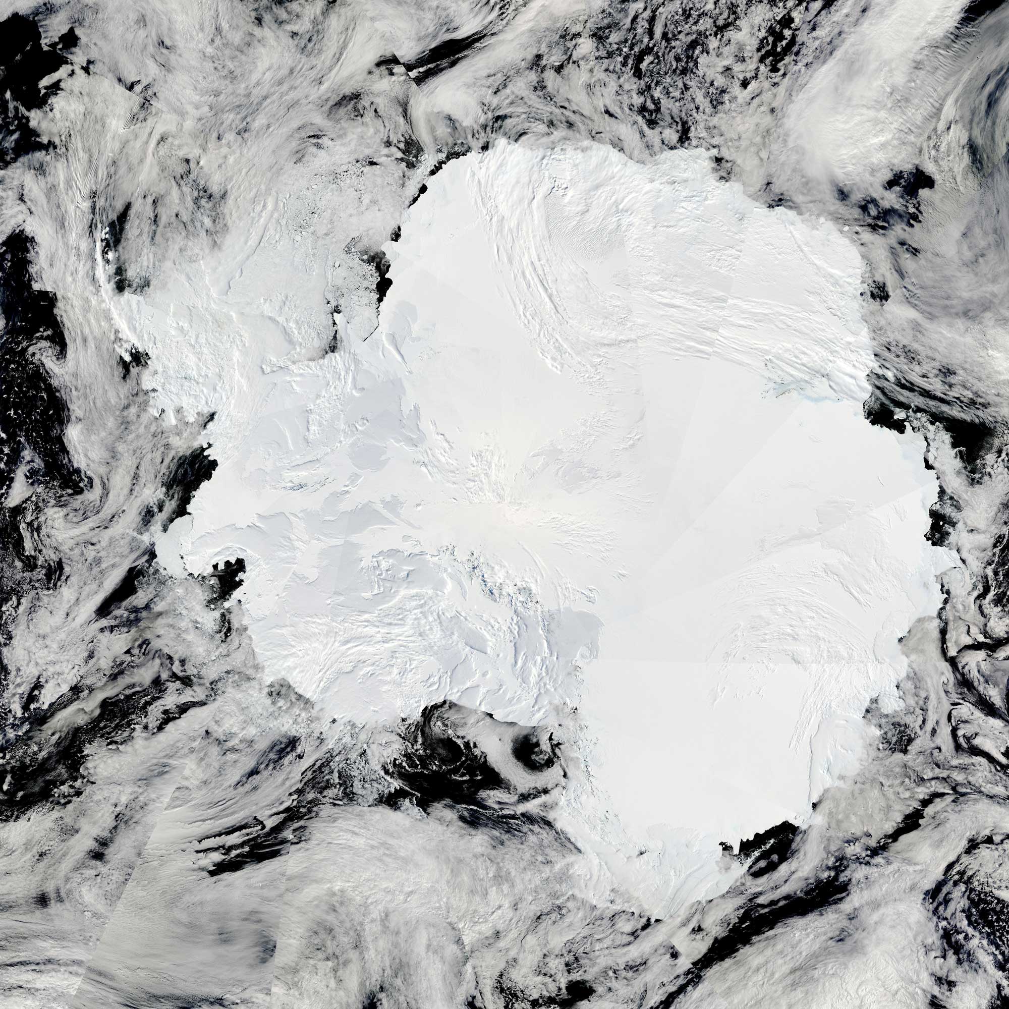 Satellite image of Antarctica showing that the continent is entirely covered with a layer of white snow and ice.
