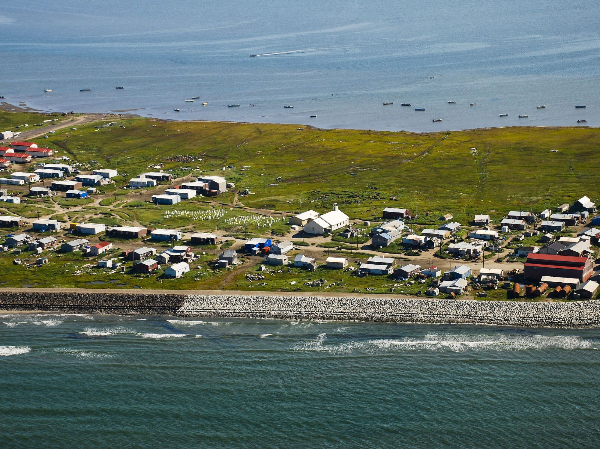 Aerial photo of the village of Shishmaref, Alaska in 2014, built on a barrier island.