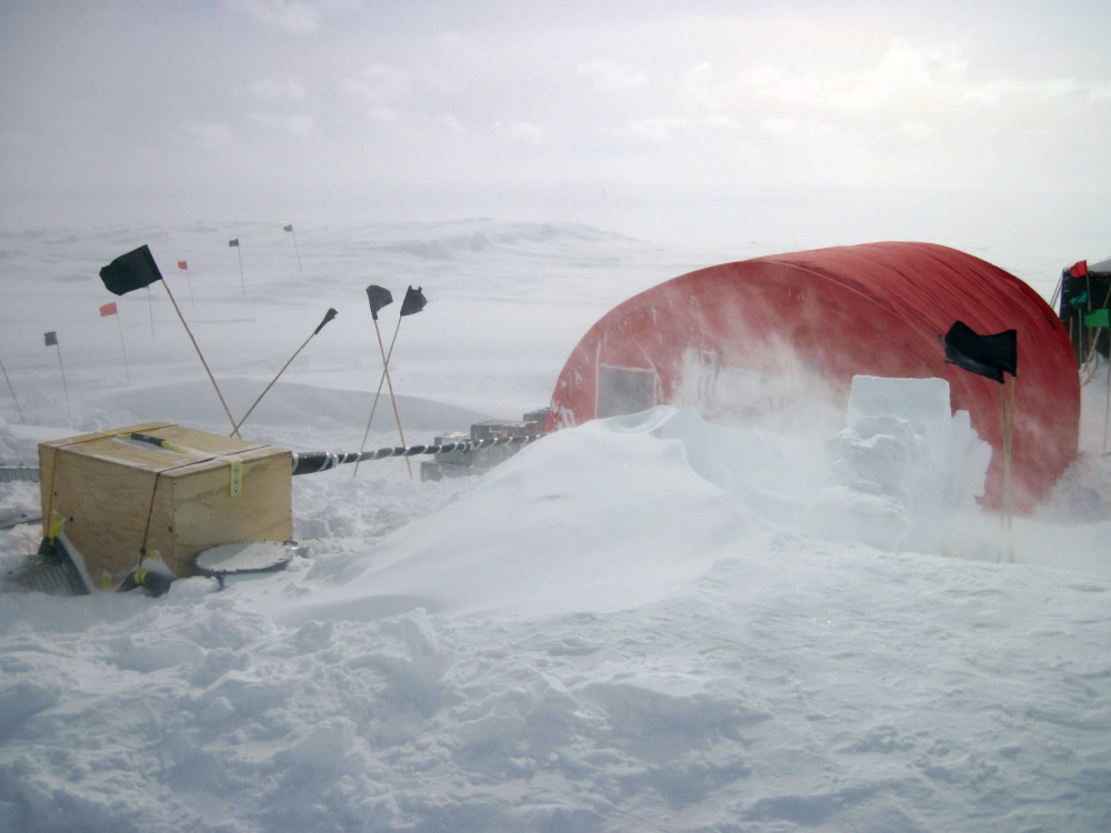 Photo of drifting snow outside a tent at an ice core drill site in Antarctica