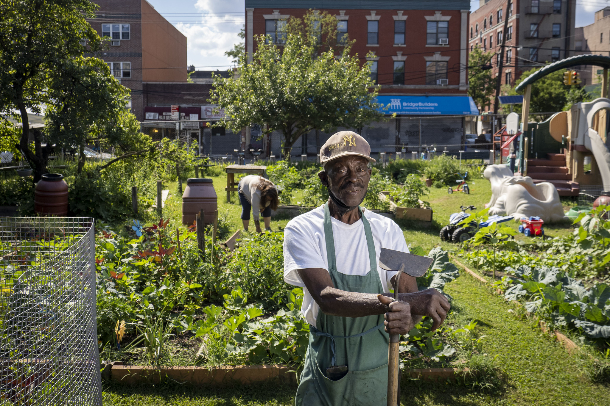 Man standing in front of a community garden in New York City