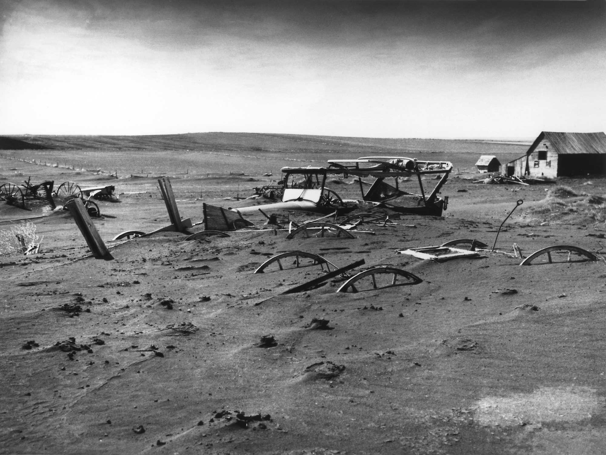 Historical photograph of a car buried during the Dust Bowl in South Dakota during the 1930s.
