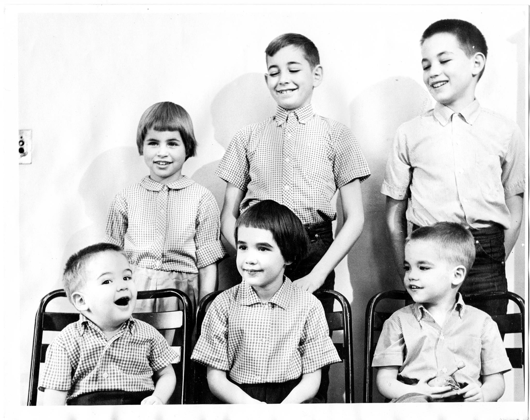 Black and white portrait of six siblings.