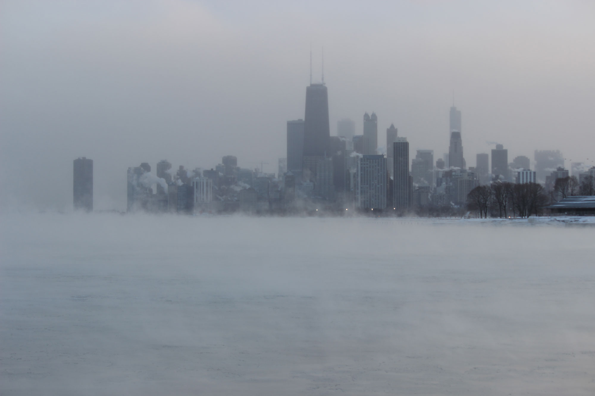 Photograph of the skyline of Chicago with a frozen Lake Michigan in the foreground during a polar vortex.