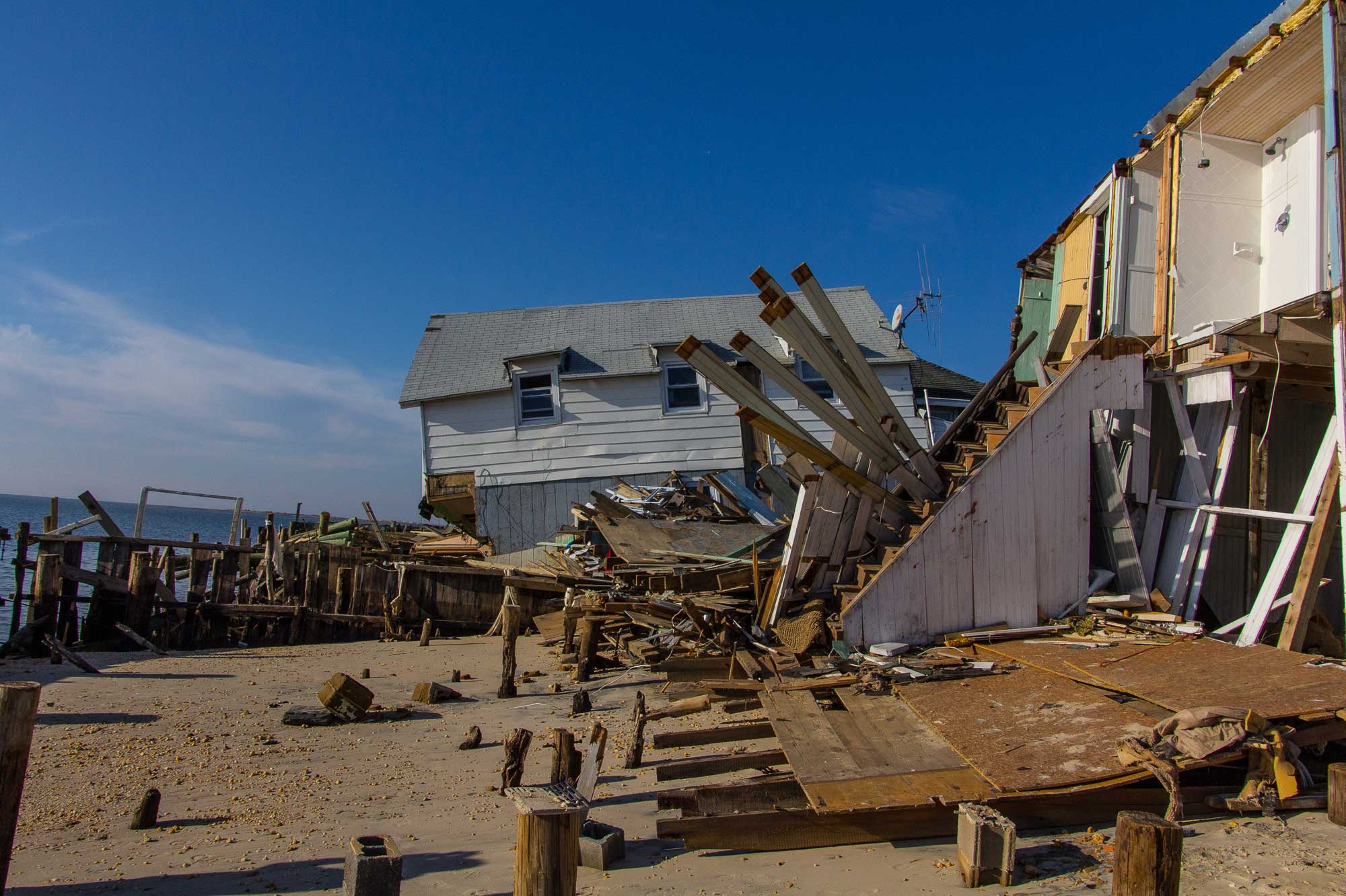 Photograph of Gandy Beach, New Jersey, following Hurricane Sandy in 2012. The photo shows houses that were built on the beach, with substantial damage on the sides that face the water.