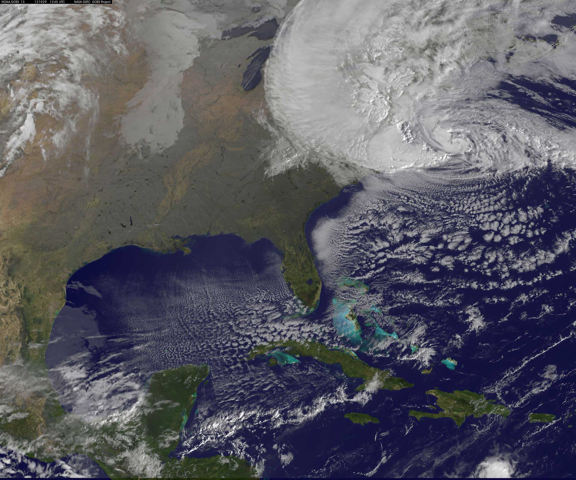 Satellite photograph of Hurricane Sandy as it hit the Northeastern U.S. on October 29, 2012. The photo shows a large cyclone sitting over the northeastern U.S., with the clouds extending west all the way to the edge of Lake Michigan in the Midwest.