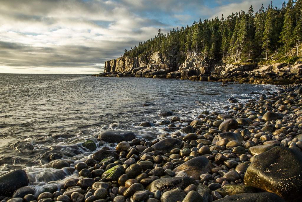 Photo showing a rocky beach at sunrise on the coast of Maine.
