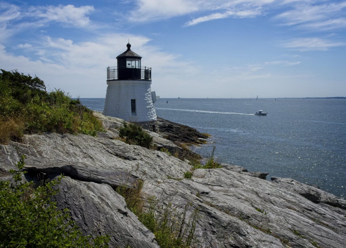 Photo of a short lighthouse on a rocky coastline.