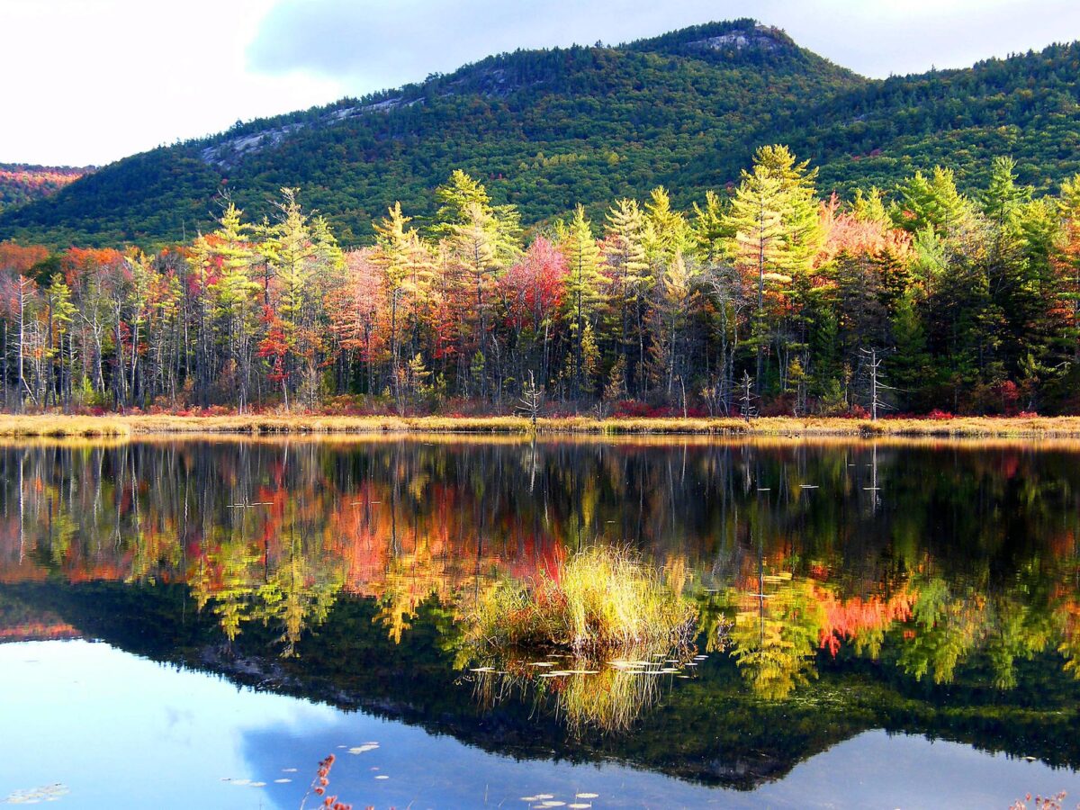 Photo of a mountain in the White Mountain range of New Hampshire, with lake in foreground.