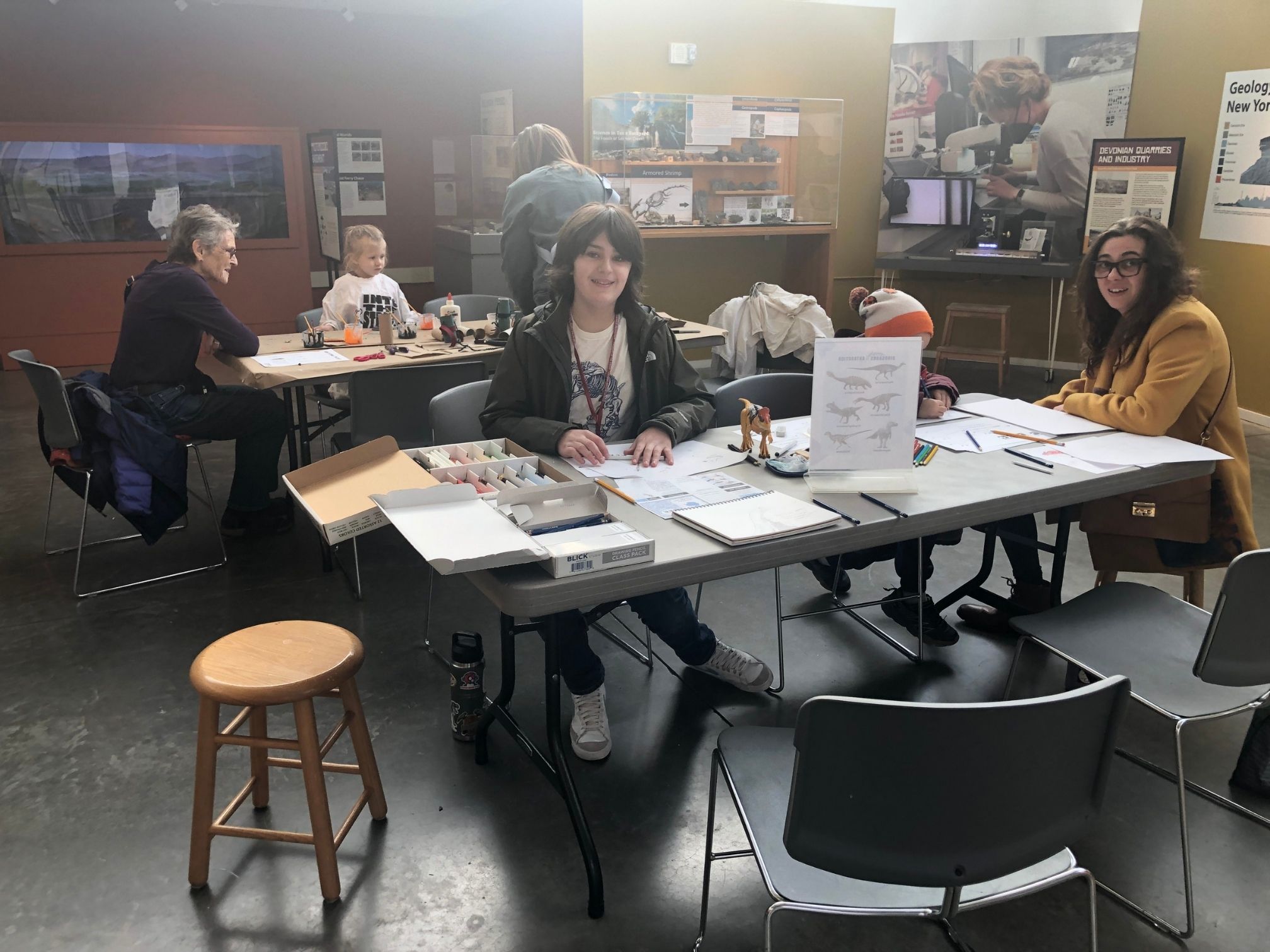 Photos of people doing craft activities at two tables in a museum